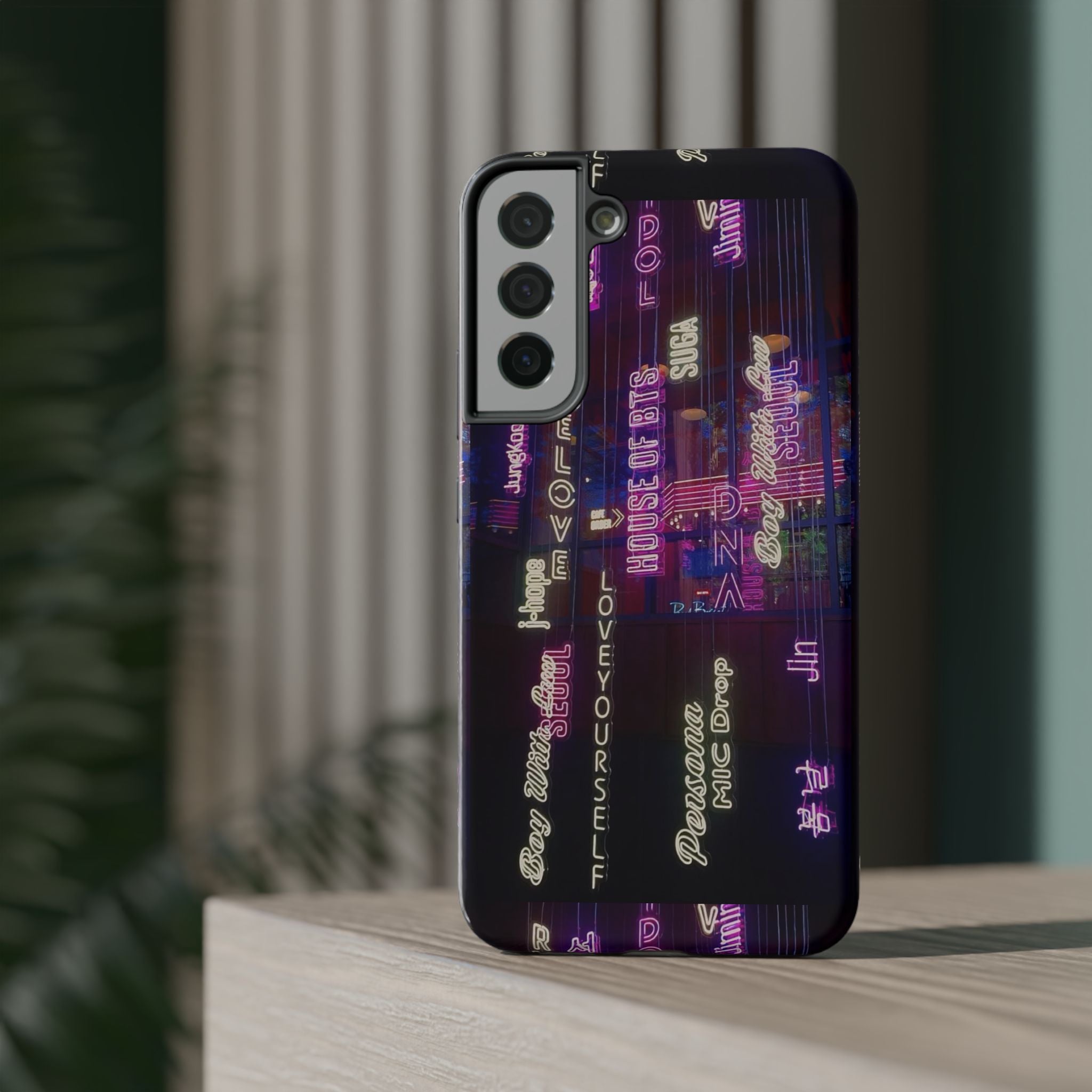 Neon Korean script BTS phone case for iPhone and Samsung, impact-resistant design with Bangtan Sonyeondan branding by Printify.